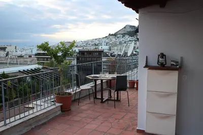 a patio with a table and chairs on a balcony at Roof Top Studio in Athens