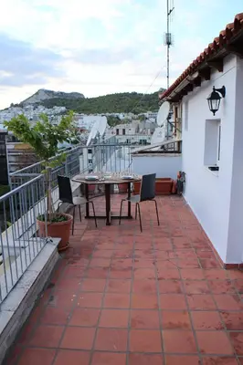 a patio with a table and chairs on a balcony at Roof Top Studio in Athens