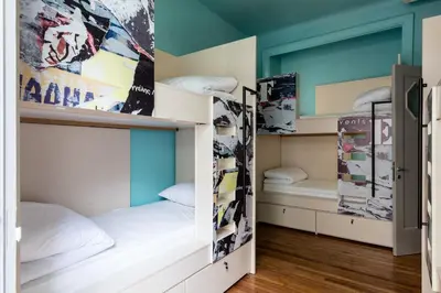 two bunk beds in a room with blue walls at Nubian Hostel in Athens