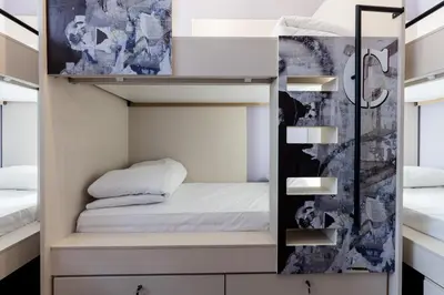 a bedroom with a bunk bed and a mirror at Nubian Hostel in Athens