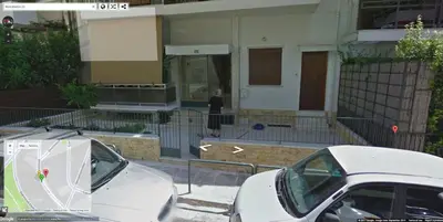 a white car parked in front of a building at Barbara's appartment in Athens