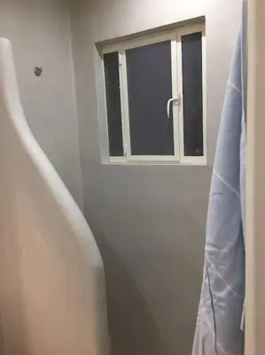 a bathroom with a window and a bath tub at 5th floor bright flat at bohemian Exarcheia in Athens
