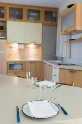 a table with a plate and wine glasses on it at Acropolis at your fingertips in Athens