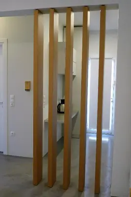 a group of wooden poles in a room at Deluxe Apartment in Vouliagmeni in Athens