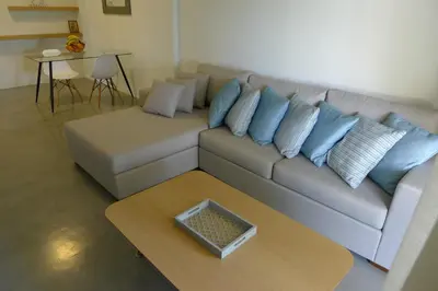 a living room with a couch and a coffee table at Deluxe Apartment in Vouliagmeni in Athens