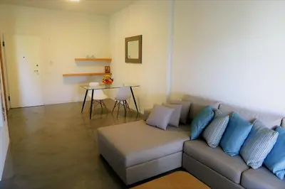 a living room with a couch and a table at Deluxe Apartment in Vouliagmeni in Athens