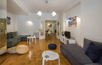 a living room with a couch and a table at Elite Downtown Central 5th Floor Apartment in Athens
