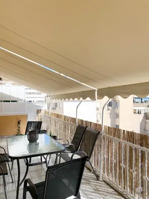 a balcony with a table and chairs on a building at Elite Downtown Central 5th Floor Apartment in Athens