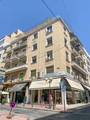 a tall building on a city street with a store at Elite Downtown Central 5th Floor Apartment in Athens