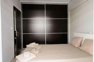 a bedroom with a bed and a black wall at Apartment & Parking 100m Kerameikos Metro in Athens