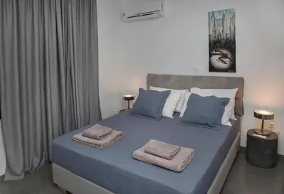 a bedroom with a bed with two towels on it at Luxury Penthouse touching the Acropolis by GHH in Athens