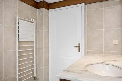 a bathroom with a sink and a shower at Cosy Relaxing Flat 60'' from Metro Station in Athens