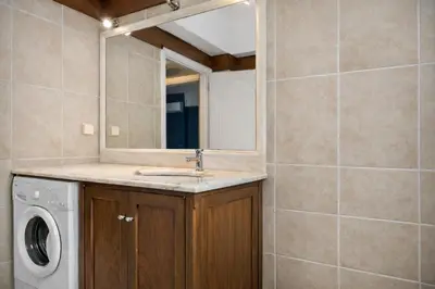 a bathroom with a washing machine and a mirror at Cosy Relaxing Flat 60'' from Metro Station in Athens