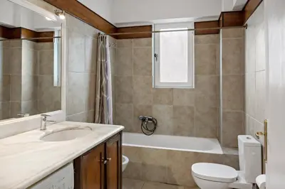a bathroom with a sink and a toilet and a tub at Cosy Relaxing Flat 60'' from Metro Station in Athens