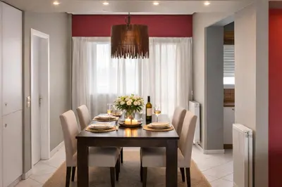 a dining room with a table with chairs and a chandelier at Cosy Relaxing Flat 60'' from Metro Station in Athens