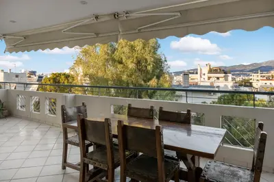 a table and chairs on a balcony with a view at Cosy Relaxing Flat 60'' from Metro Station in Athens