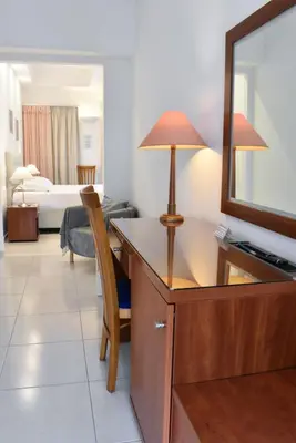 a hotel room with a desk and a mirror at Acqua Marina - Άκουα Μαρίνα in Agia Marina Aegina