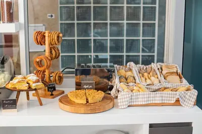 a table with various types of bread and pastries at Acropolis View Hotel in Athens