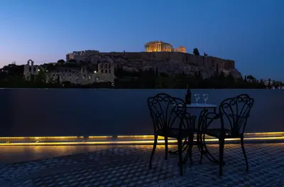 a table and chairs with a view of a castle at Acropolis View Hotel in Athens