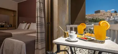 a hotel room with a table with a tray of food at Acropolis View Hotel in Athens