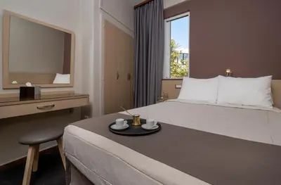 a hotel room with a bed and a mirror at Acropolis View Hotel in Athens