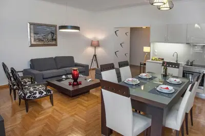 a kitchen and a living room with a table and a couch at Exceptional Penthouse close to Acropolis Museum by GHH in Athens