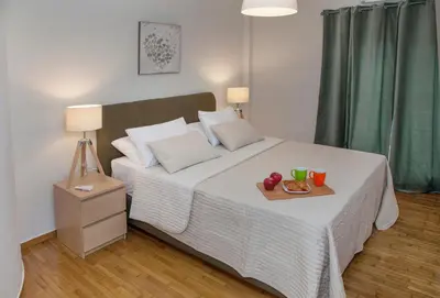 a bedroom with a bed with a tray of fruit on it at Exceptional Penthouse close to Acropolis Museum by GHH in Athens