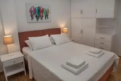 a bedroom with a white bed with towels on it at Exceptional Penthouse close to Acropolis Museum by GHH in Athens