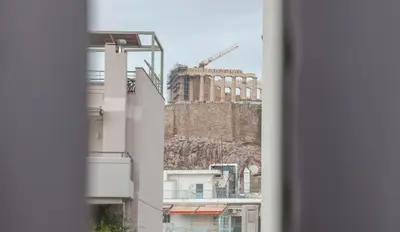 a view of a building from a window at Exceptional Penthouse close to Acropolis Museum by GHH in Athens