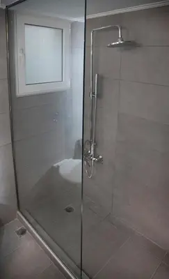 a shower with a glass door in a bathroom at Exceptional Penthouse close to Acropolis Museum by GHH in Athens