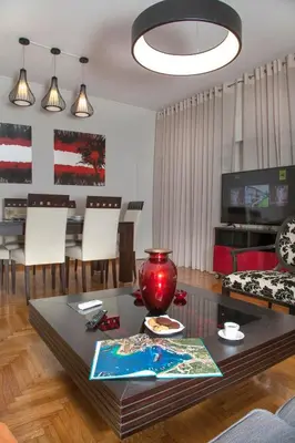 a living room with a table and a dining room at Exceptional Penthouse close to Acropolis Museum by GHH in Athens