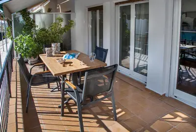 a wooden table and chairs on a patio at Exceptional Penthouse close to Acropolis Museum by GHH in Athens