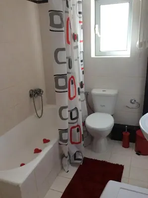 a bathroom with a toilet and a shower curtain at Sunny apartment in Athens