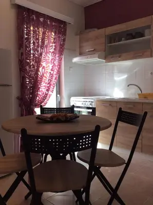 a kitchen with a table and chairs in a kitchen at Sunny apartment in Athens