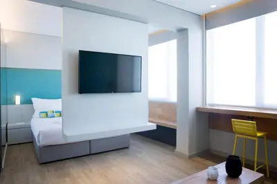 a room with a bed and a tv on a wall at Athenaeum K 29 in Athens