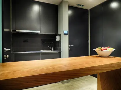 a kitchen with a bowl of fruit on a wooden table at Athenaeum K 29 in Athens