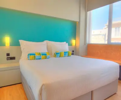 a bedroom with a large white bed with two pillows at Athenaeum K 29 in Athens