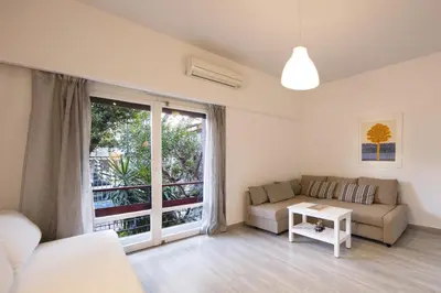 a living room with a couch and a table at Artistic apartment next to everything in Athens