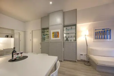 a white room with a white table and a couch at Artistic apartment next to everything in Athens