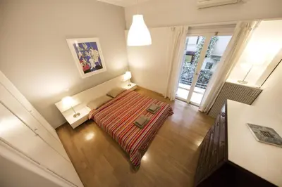 a small room with a bed and a table at Artistic apartment next to everything in Athens