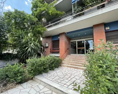 a brick house with a staircase in front of it at Artistic apartment next to everything in Athens