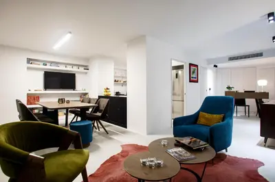 a living room with blue chairs and a table at Vol.5 in Athens