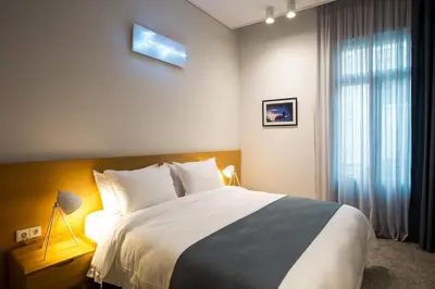 a bedroom with a large bed and a window at Vol.5 in Athens
