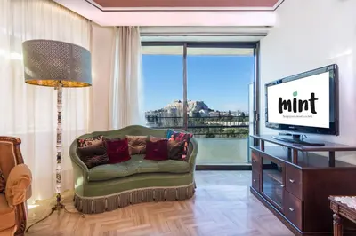a living room with a couch and a flat screen tv at Acropolis View apartment 120sqm in Athens