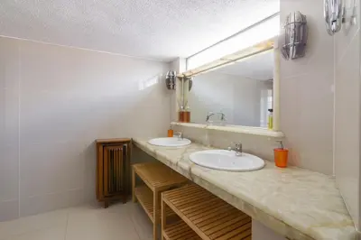 a bathroom with two sinks and a mirror at Acropolis View apartment 120sqm in Athens