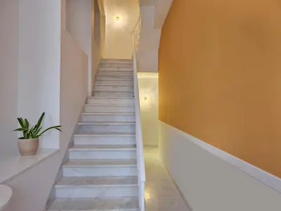 a staircase in a house with a potted plant at Astikon House in Athens