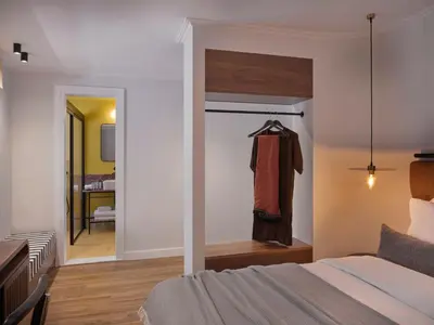 a bedroom with a bed and a room with a hallway at Astikon House in Athens