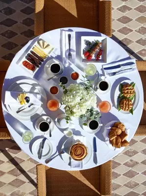 a table with a plate of food on it at Grand Resort Lagonissi in Lagonissi