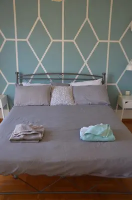 a bed with two towels sitting on top of it at Home Sweet Home in Athens