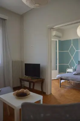 a living room with a bed and a table at Home Sweet Home in Athens